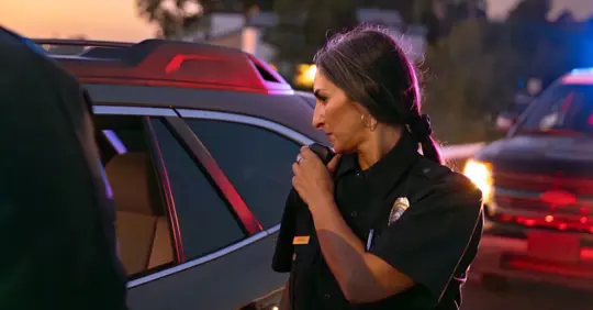 female police officer stopping a car
